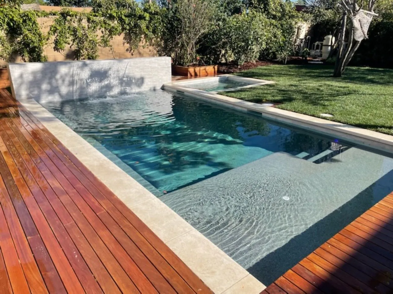 After: Finished narrow pool with a raised spa.
